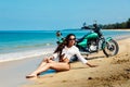 Young girl in a bathing suit on a beach with the motorcycle Royalty Free Stock Photo