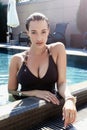 Young girl with big breasts sitting in the swimming pool Royalty Free Stock Photo