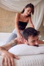 Young sexy girl giving massage to her boyfriend