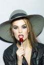 Young girl in a hat with lollipop Royalty Free Stock Photo