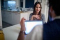 A young sexy girl having an interview for a job with a young handsome businessman at his home office. Business, interview, people Royalty Free Stock Photo