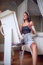 Young sexy girl painter happy about her work