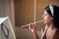 Young sexy girl painter passionate about her work