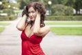 Young sexy girl in red dress in the park Royalty Free Stock Photo