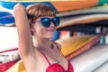 Young girl in red swimsuit - surfer with surf board posing on the Nusa Dua beach, tropical Bali island, Indonesia Royalty Free Stock Photo