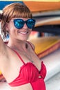 Young girl in red swimsuit - surfer with surf board posing on the Nusa Dua beach, tropical Bali island, Indonesia Royalty Free Stock Photo