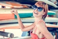 Young girl in red swimsuit - surfer with surf board posing on the Nusa Dua beach, tropical Bali island, Indonesia Royalty Free Stock Photo