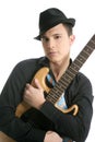 Young male guitar player, tie and black hat Royalty Free Stock Photo