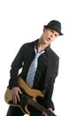 Young male guitar player, tie and black hat Royalty Free Stock Photo