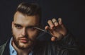 Young sexy man, portrait of guy with barber scissors for barber shop. Modern barbershop, shaving. Handsome male with Royalty Free Stock Photo