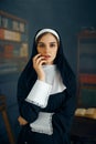 Young sexy nun in a cassock, vicious desires