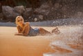 Young sexy and relaxed blond woman in one piece swimsuit lying on the sand looking at sea enjoying summer holidays at beautiful Royalty Free Stock Photo