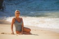 Young sexy and relaxed blond woman in one piece swimsuit lying on the sand looking at sea enjoying summer holidays at beautiful Royalty Free Stock Photo