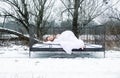 Young, sexy, seductive, brunette woman lying in the cold snowy winter nature in bed, with, soft, white sheets and pillow, copy Royalty Free Stock Photo