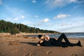 Young sensual couple laying and hugging on sand at the beach. Passion between two lovers. Sex and love on the beach. Royalty Free Stock Photo