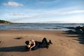 Young sensual couple laying and hugging on sand at the beach. Passion between two lovers. Sex and love on the beach. Royalty Free Stock Photo