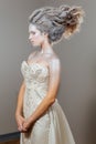 Young snow queen princess. Beautiful snowy hairstyle. Decollete. Fashion.