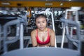 and sweaty Asian woman training hard at gym using elliptical pedaling machine gear in intense workout Royalty Free Stock Photo