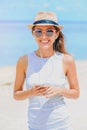 Young woman with earphones using phone on the beach Royalty Free Stock Photo