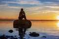 Beautiful women girl are sitting on a stone Royalty Free Stock Photo