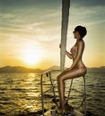 Young woman on her private yacht at sunset Royalty Free Stock Photo