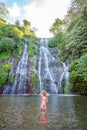 Young woman in swimsuit in front of Banyumala twin waterfalls on Bali Royalty Free Stock Photo