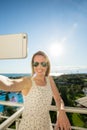 Woman is pointing with her finger to the sea from a balkony in summer holiday Royalty Free Stock Photo