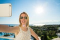 Woman is pointing with her finger to the sea from a balkony in summer holiday Royalty Free Stock Photo