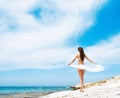 Young and woman posing in a white swimsuit and holding silk Royalty Free Stock Photo