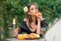 Young sexy woman relaxing and eating fruit outdoor. Exotic summer diet, tropical fruits. Royalty Free Stock Photo