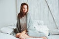 Young woman relaxing at home in bed in cozy winter weekend morning Royalty Free Stock Photo