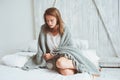 Young woman relaxing at home in bed in cozy winter weekend morning Royalty Free Stock Photo