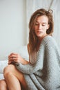 Young woman relaxing at home in bed in cozy winter weekend morning Royalty Free Stock Photo