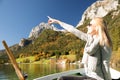 Woman is rowing with a rowing boat with a lake in the mountains Royalty Free Stock Photo