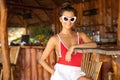 Young and sexy woman sitting in authentic beach bar with a coconut drink Royalty Free Stock Photo
