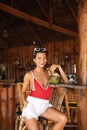 Young and sexy woman sitting in authentic beach bar with a coconut drink Royalty Free Stock Photo