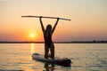 Young woman swimming on stand up paddle board.Water sports , active lifestyle.