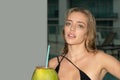 Young sexy woman in swimsuit drinking coconut drink. Closeup portrait of young woman with coconut cocktail. Royalty Free Stock Photo