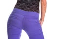 Young woman is wearing purple jeans. Rear view. Royalty Free Stock Photo