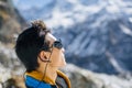 Young Sherpa looking at one of summits