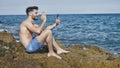 Handsome man doing videochat at sea