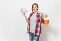 Young shocked beautiful woman in casual clothes holding bundle of dollars, cash money and paint bucket isolated on white Royalty Free Stock Photo