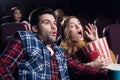 young shocked couple with popcorn watching movie Royalty Free Stock Photo