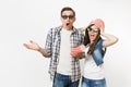 Young shocked couple, woman and man in 3d glasses with bucket for popcorn on head watching movie film on date, holding Royalty Free Stock Photo