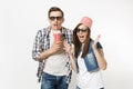 Young shocked couple, woman and man in 3d glasses with bucket for popcorn on head watching movie film on date, holding Royalty Free Stock Photo