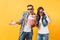 Young shocked couple woman man in 3d glasses watching movie film on date holding bucket of popcorn plastic cup of soda Royalty Free Stock Photo