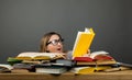 Young shocked girl in glasses stunned with information in book Royalty Free Stock Photo