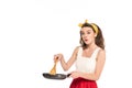 Shocked housewife in dress and apron holding frying pan and wooden spatula isolated on white Royalty Free Stock Photo