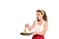 Shocked housewife in dress and apron looking at frying pan and wooden spatula isolated on white Royalty Free Stock Photo