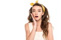 Shocked housewife in dress and headband looking at camera isolated on white Royalty Free Stock Photo